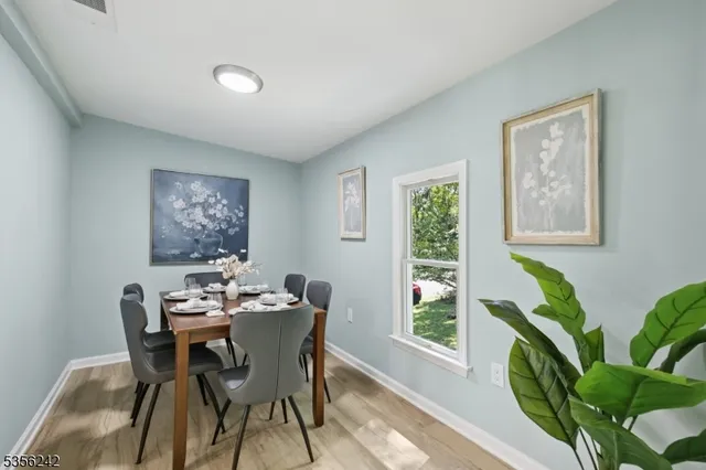a dining room with furniture and wooden floor