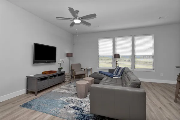 a kitchen with stainless steel appliances a sink a stove a refrigerator cabinets and wooden floor