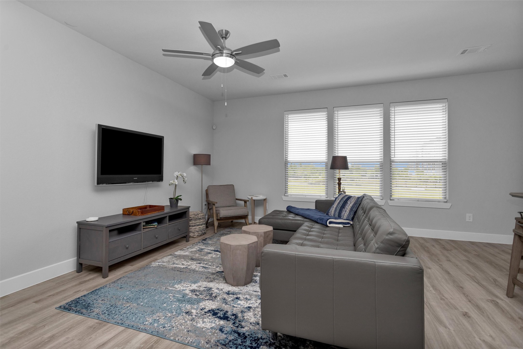 454 South Centro Circle Conroe, TX 77385 - Photo 12 of 34 a living room with furniture and a flat screen tv