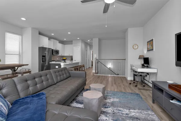 a kitchen with a sink a refrigerator and cabinets