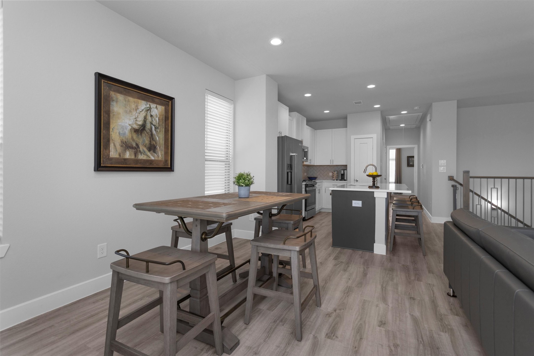 454 South Centro Circle Conroe, TX 77385 - Photo 15 of 34 a kitchen with stainless steel appliances kitchen island granite countertop a table chairs and a refrigerator