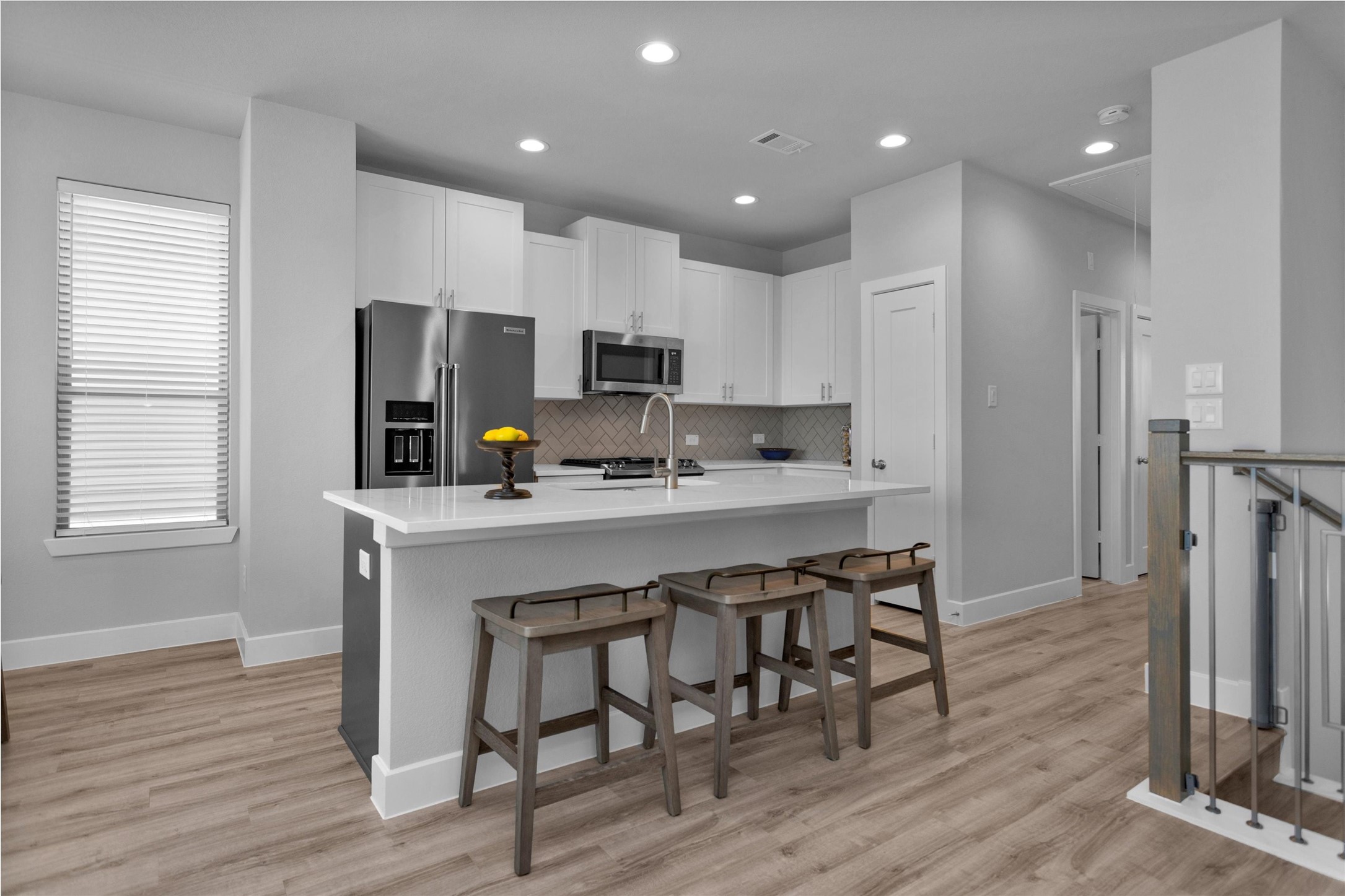 454 South Centro Circle Conroe, TX 77385 - Photo 18 of 34 a kitchen with stainless steel appliances a sink a stove a refrigerator cabinets and wooden floor