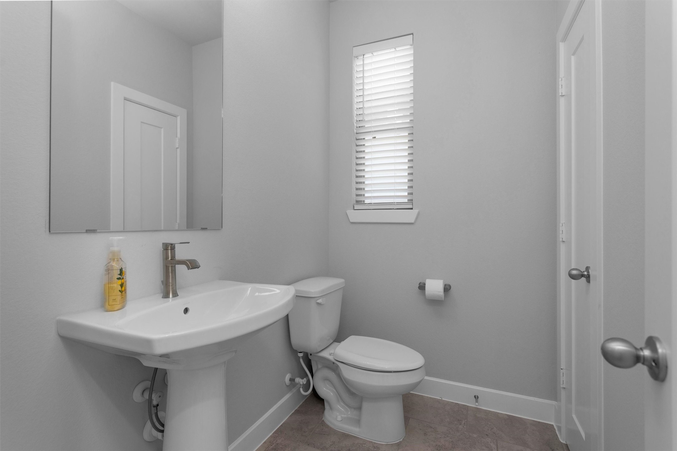 454 South Centro Circle Conroe, TX 77385 - Photo 23 of 34 a bathroom with a sink a toilet and mirror