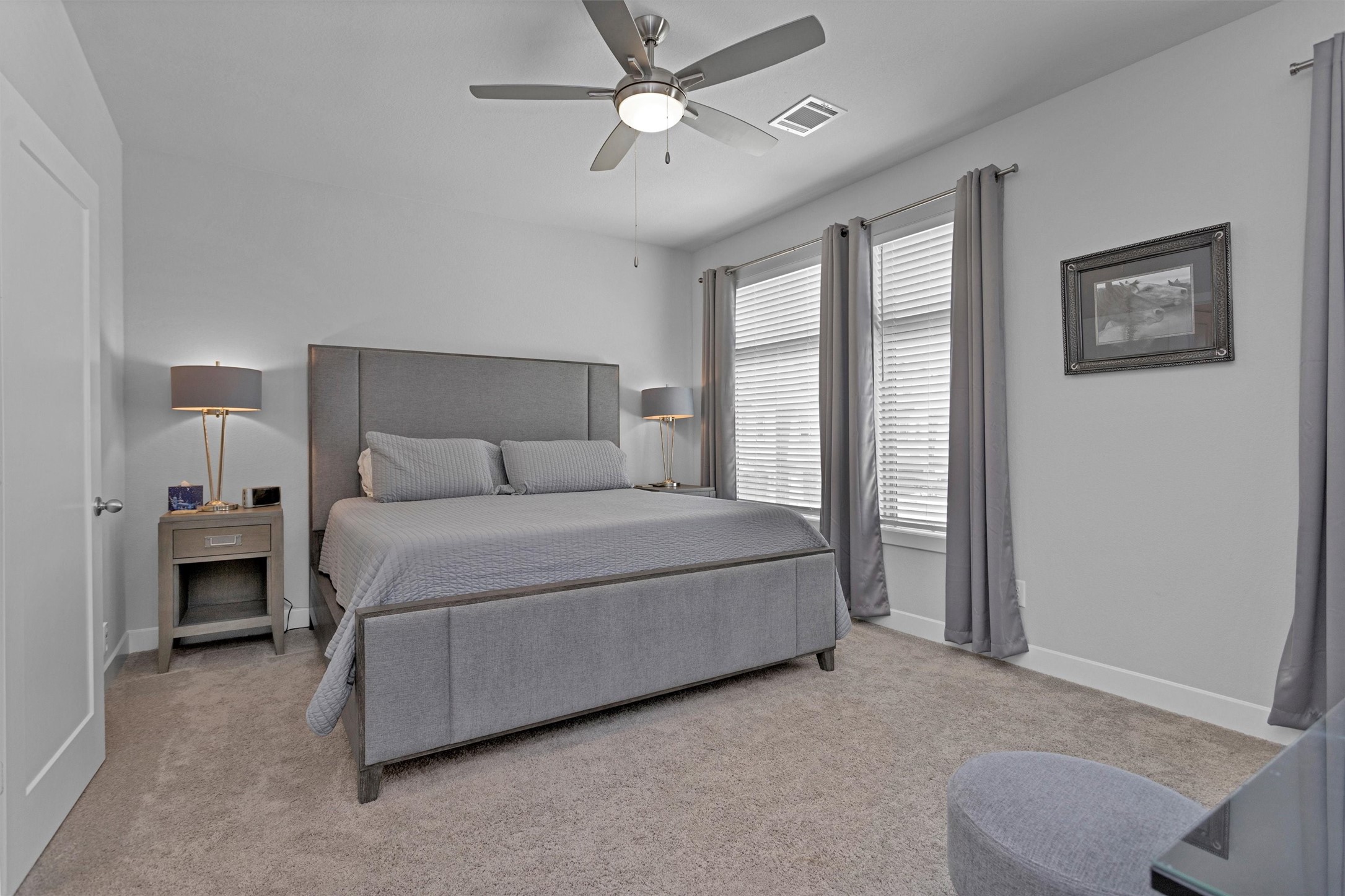 454 South Centro Circle Conroe, TX 77385 - Photo 24 of 34 a bedroom with a bed and a chandelier