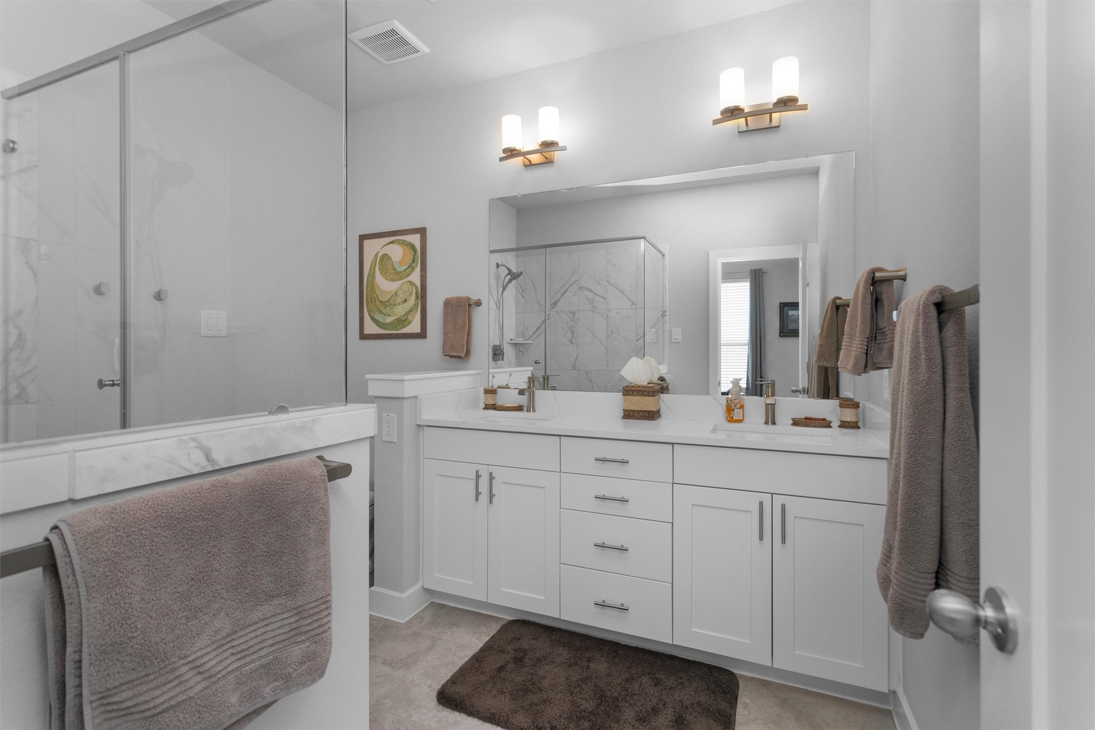 454 South Centro Circle Conroe, TX 77385 - Photo 28 of 34 a spacious bathroom with 2 sink and a mirror