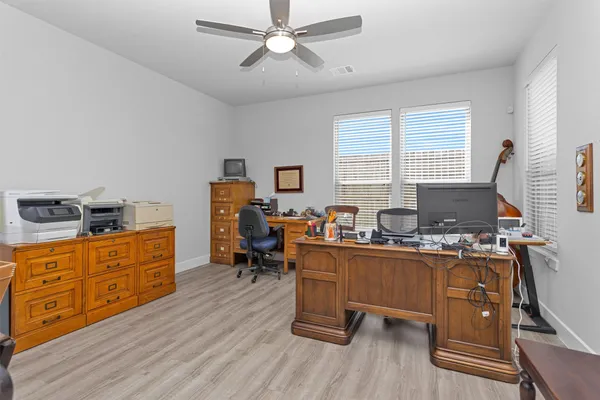 a work room with furniture and wooden floor