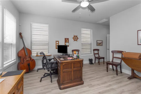 a spacious bathroom with a granite countertop sink a mirror a shower and a bathtub
