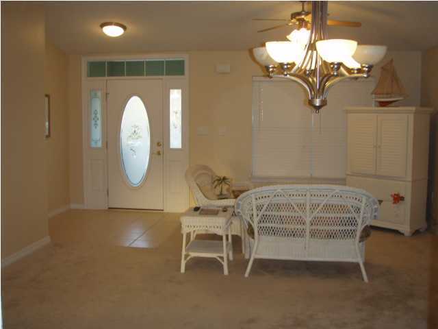138 South Harborview Road Santa Rosa Beach, FL 32459 - Photo 4 of 12 a bedroom with a bed and a chandelier