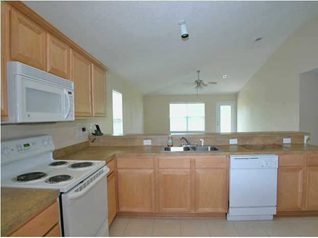 138 South Harborview Road Santa Rosa Beach, FL 32459 - Photo 7 of 12 a kitchen with a sink a stove a microwave and cabinets