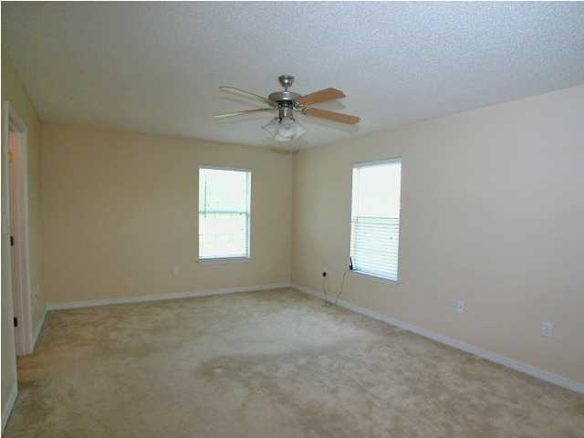 138 South Harborview Road Santa Rosa Beach, FL 32459 - Photo 8 of 12 an empty room with windows and fan