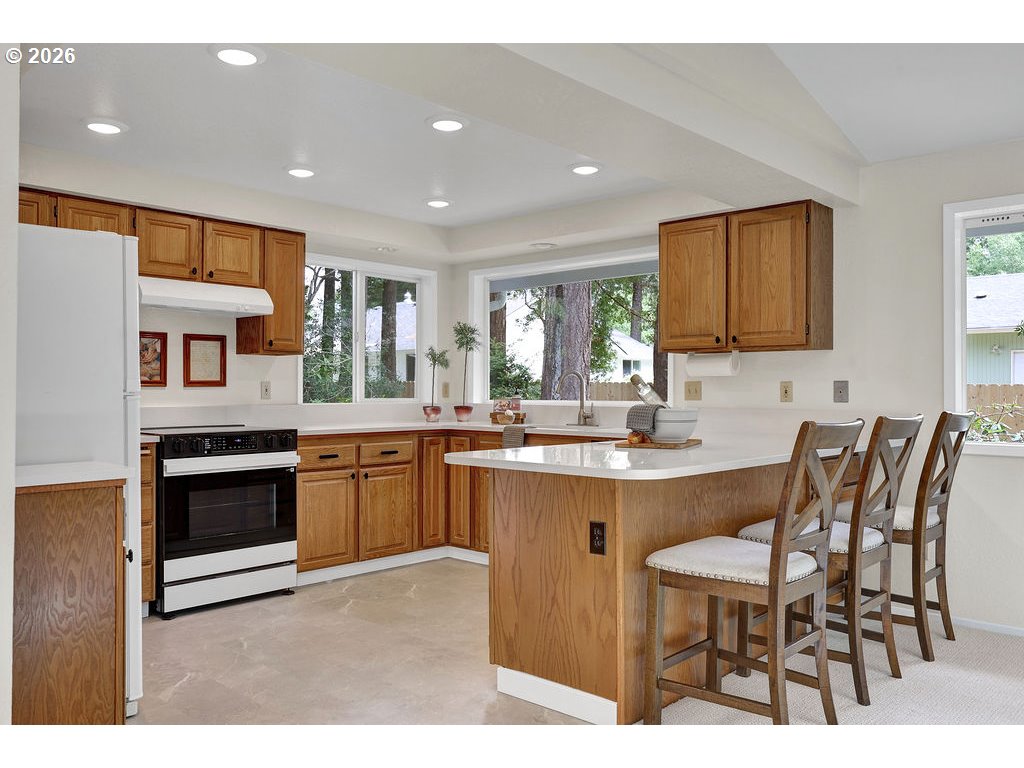2372 South 22nd Court Florence, OR 97439 - Photo 4 of 33 a kitchen with cabinets and chairs