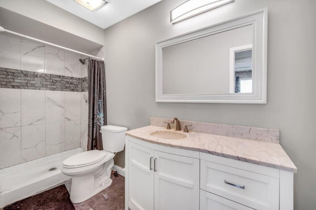 809 West 126th Court Crown Point, IN 46307 - Photo 2 of 47 a bathroom with a sink a toilet and shower