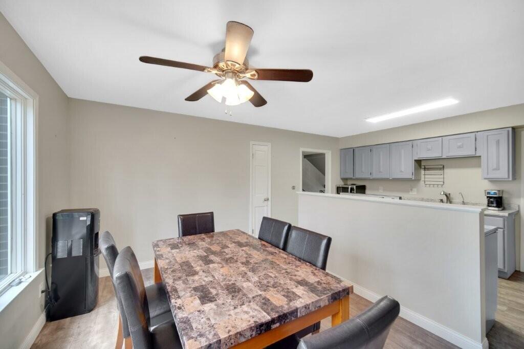 809 West 126th Court Crown Point, IN 46307 - Photo 22 of 47 a living room with stainless steel appliances kitchen island a table chairs and a refrigerator