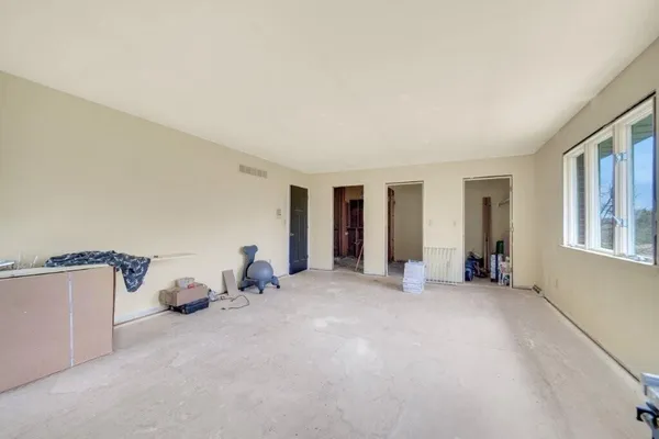 a big room with closet and large windows