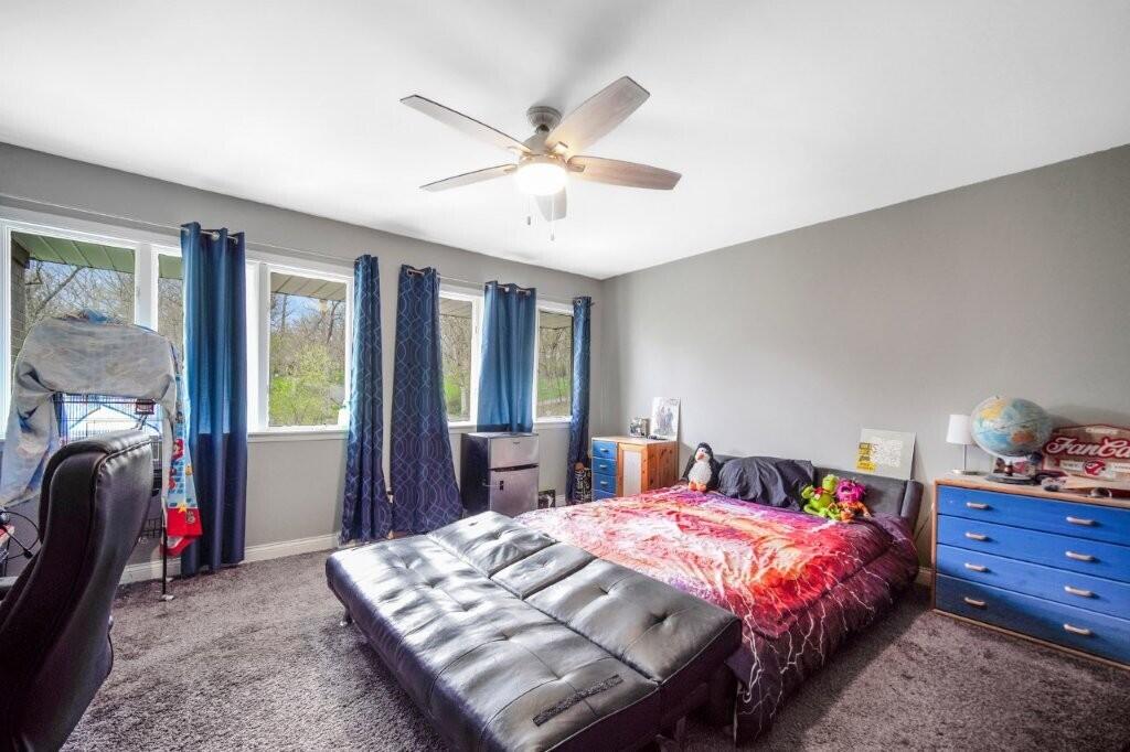 809 West 126th Court Crown Point, IN 46307 - Photo 31 of 47 a bedroom with a bed and a chandelier