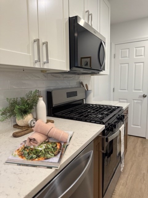 102 Crawford Street Fall River, MA 02724 - Photo 2 of 28 a kitchen with stainless steel appliances kitchen island a stove and a microwave
