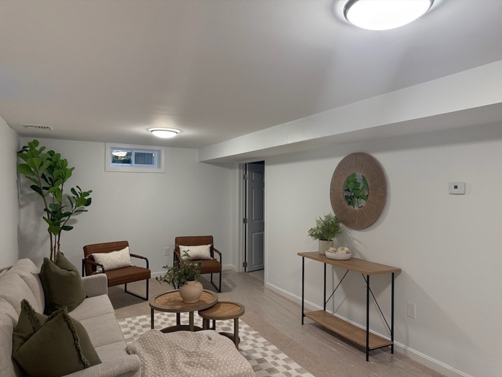 102 Crawford Street Fall River, MA 02724 - Photo 22 of 28 a living room with furniture a clock and a potted plant
