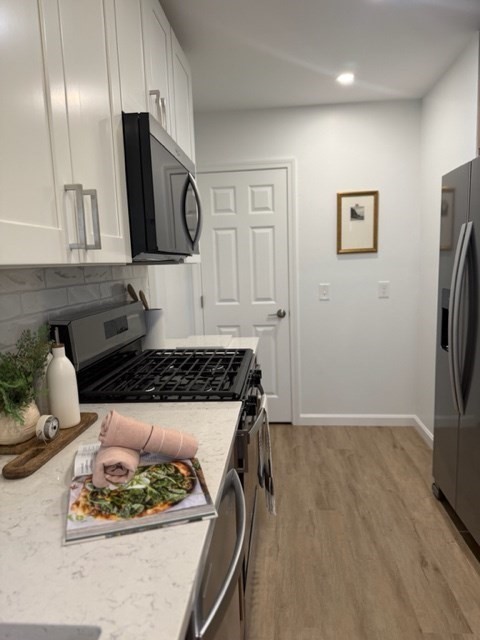102 Crawford Street Fall River, MA 02724 - Photo 3 of 28 a kitchen with a refrigerator and a stove top oven
