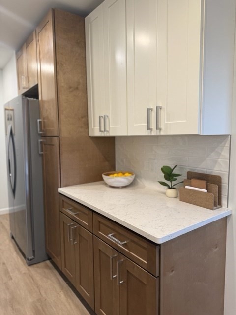 102 Crawford Street Fall River, MA 02724 - Photo 4 of 28 a kitchen with stainless steel appliances a sink a refrigerator and wooden cabinets