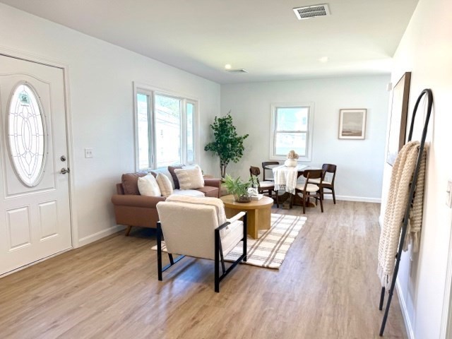 102 Crawford Street Fall River, MA 02724 - Photo 6 of 28 a living room with furniture a dining table wooden floor and a large window