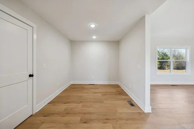 wooden floor in an empty room with a window