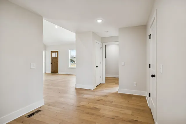 a view of an empty room with wooden floor