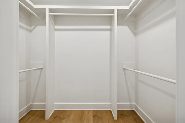 a view of walk in closet with empty racks