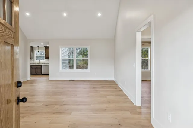 a view of an entryway with wooden floor and a window