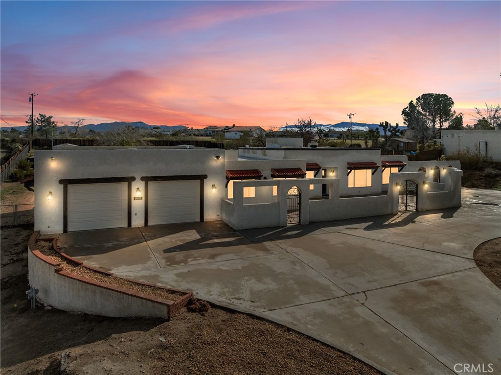 a view of roof deck with couches and sky view