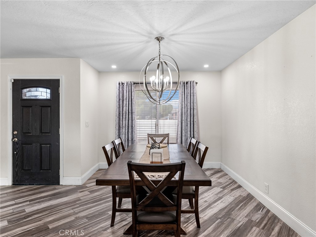 15485 Chole Road Apple Valley, CA 92307 - Photo 11 of 60 a view of a dining room with furniture window and wooden floor