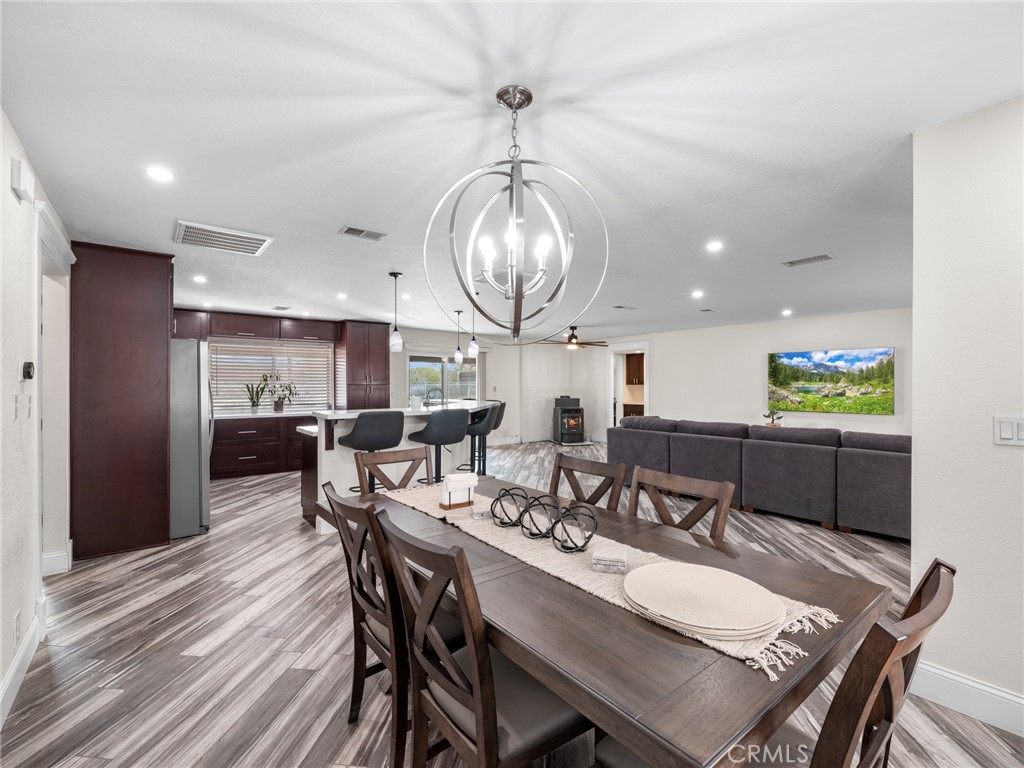 15485 Chole Road Apple Valley, CA 92307 - Photo 12 of 60 a view of a dining room with furniture window and wooden floor