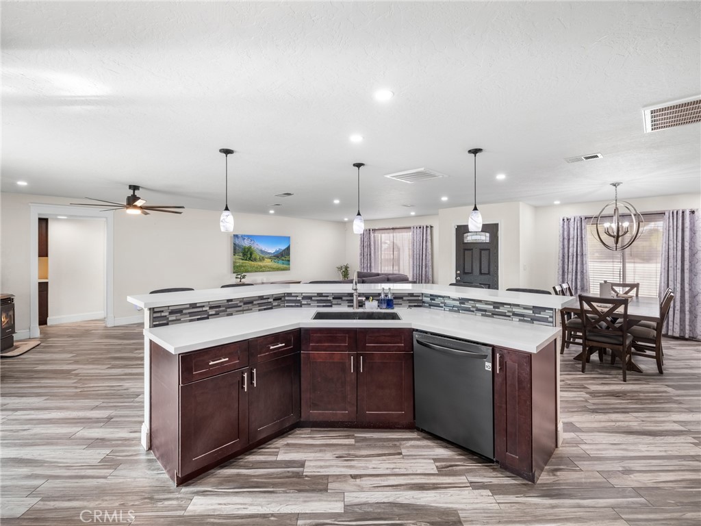 15485 Chole Road Apple Valley, CA 92307 - Photo 15 of 60 a large kitchen with stainless steel appliances kitchen island granite countertop a stove and a sink