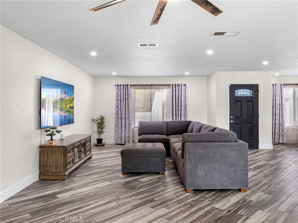 15485 Chole Road Apple Valley, CA 92307 - Photo 19 of 60 a living room with furniture and a wooden floor