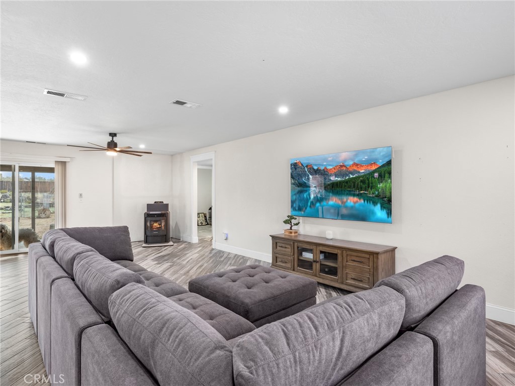15485 Chole Road Apple Valley, CA 92307 - Photo 20 of 60 a living room with furniture and a flat screen tv