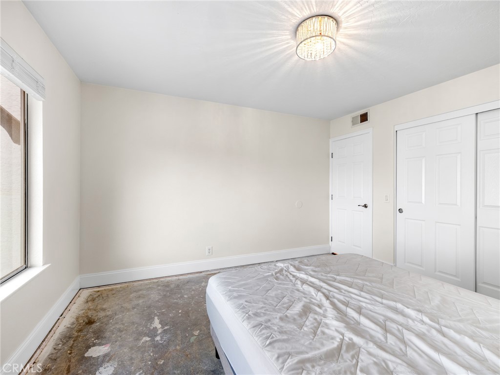 15485 Chole Road Apple Valley, CA 92307 - Photo 27 of 60 a bedroom with a bed and a window