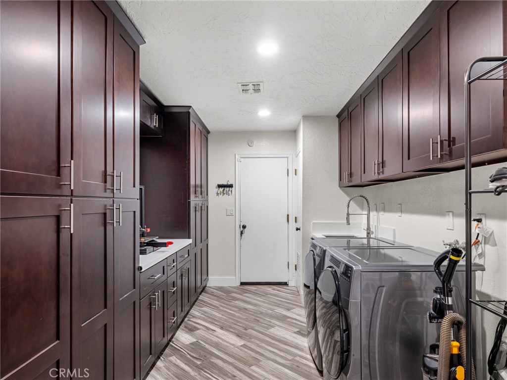15485 Chole Road Apple Valley, CA 92307 - Photo 28 of 60 a kitchen with stainless steel appliances granite countertop stainless steel appliances wooden cabinets and granite counter tops