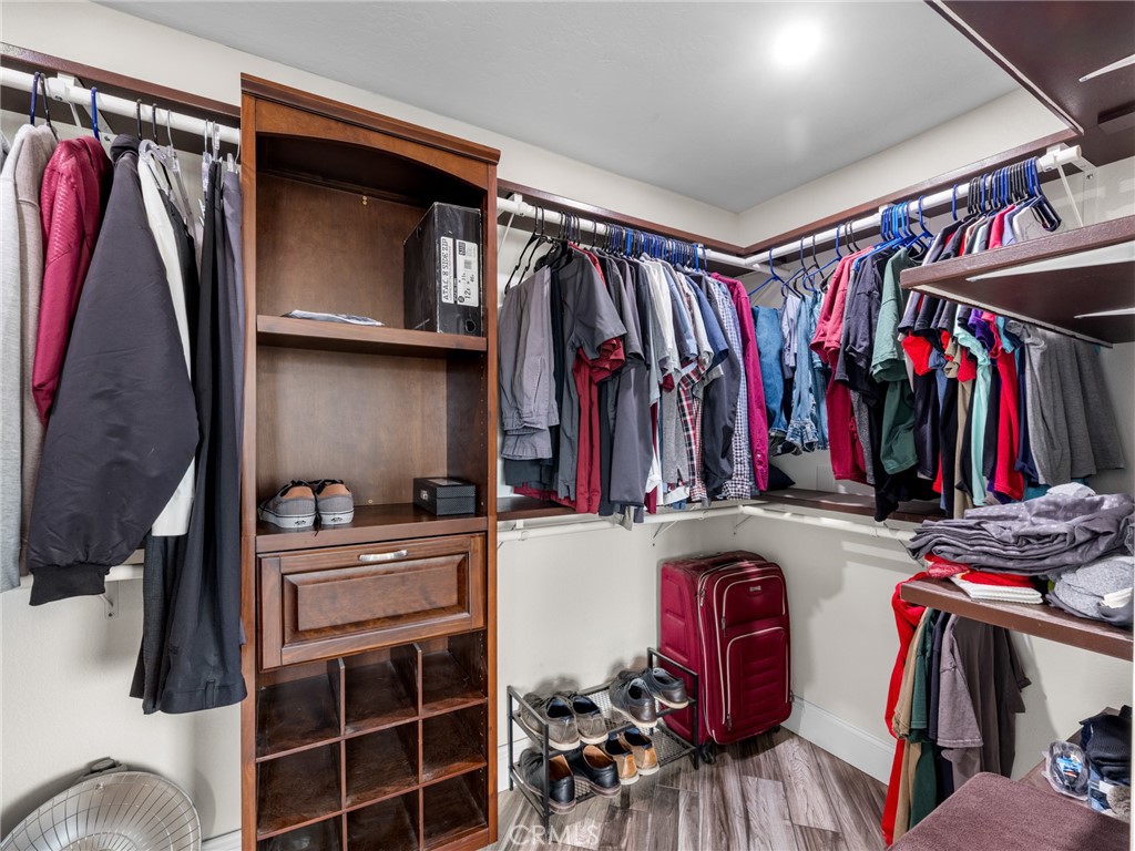 15485 Chole Road Apple Valley, CA 92307 - Photo 35 of 60 a view of walk in closet with clothes and shoes