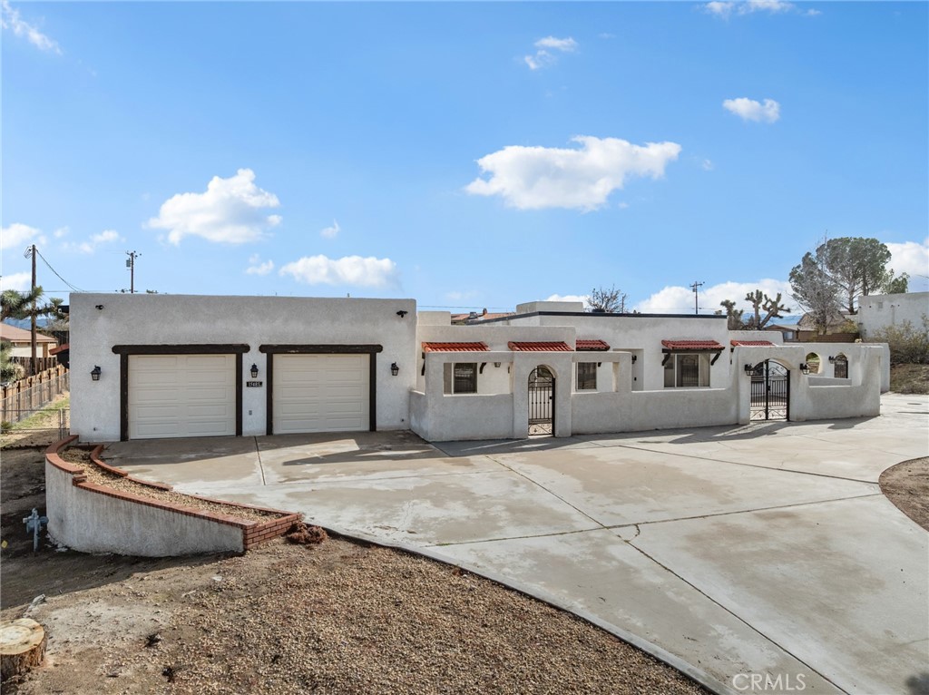 15485 Chole Road Apple Valley, CA 92307 - Photo 45 of 60 a view of a house with a patio and a yard