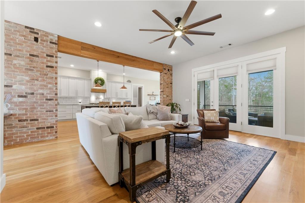 6754 Gaines Ferry Road Flowery Branch, GA 30542 - Photo 12 of 85 a living room with furniture wooden floor and a rug
