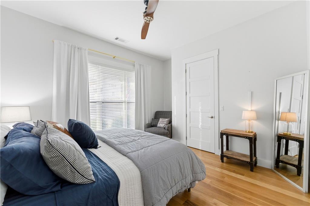 6754 Gaines Ferry Road Flowery Branch, GA 30542 - Photo 20 of 85 a bedroom with a bed a mirror and a window