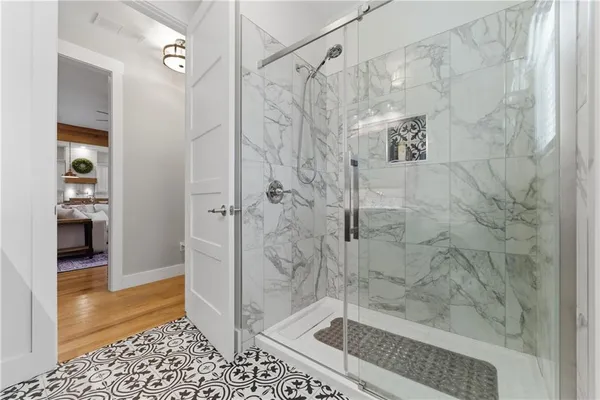 a bathroom with a granite countertop sink toilet mirror and shower