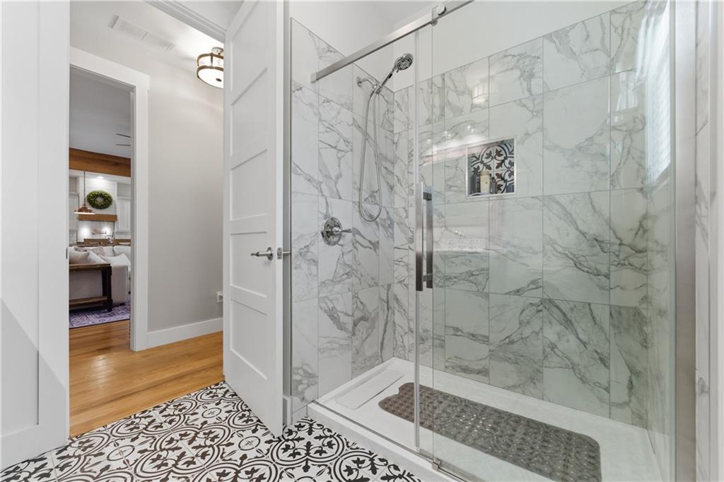 6754 Gaines Ferry Road Flowery Branch, GA 30542 - Photo 25 of 85 a bathroom with a shower and a toilet