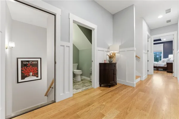 a living room with furniture a flat screen tv and a floor to ceiling window