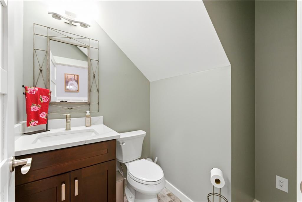 6754 Gaines Ferry Road Flowery Branch, GA 30542 - Photo 28 of 85 a bathroom with a toilet sink vanity and mirror