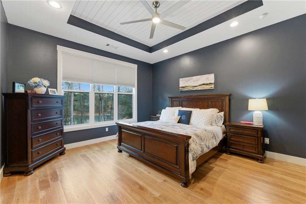 6754 Gaines Ferry Road Flowery Branch, GA 30542 - Photo 31 of 85 a spacious bedroom with a bed and a dresser