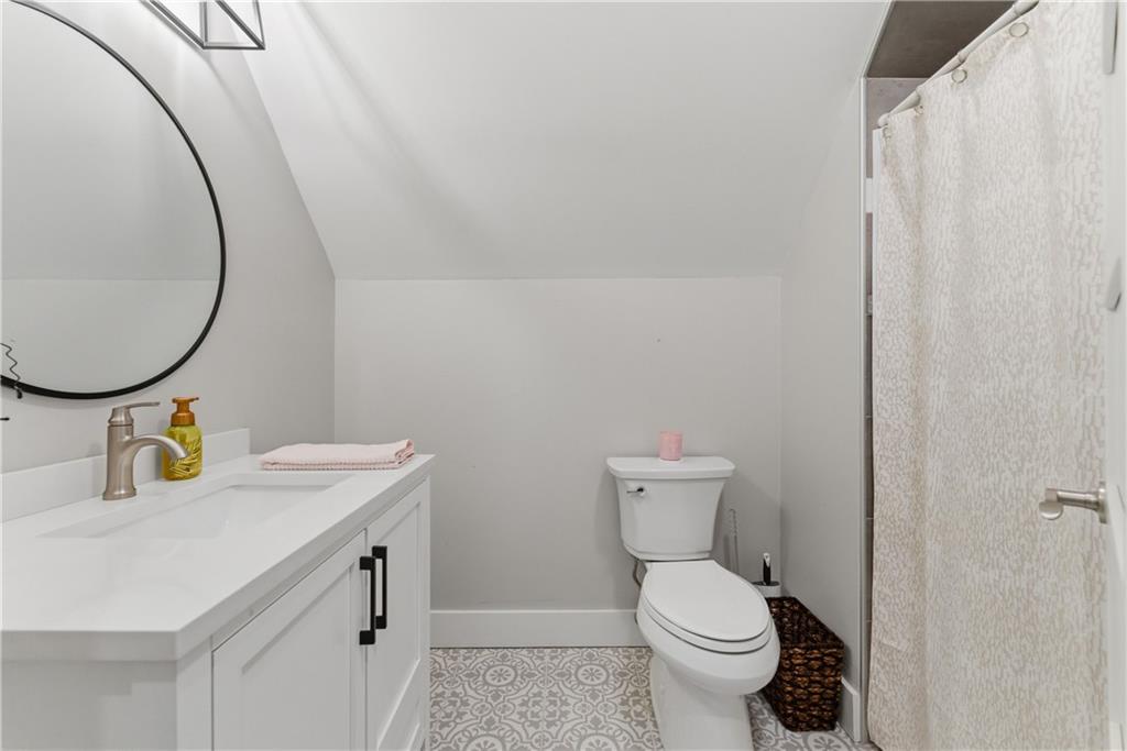 6754 Gaines Ferry Road Flowery Branch, GA 30542 - Photo 40 of 85 a bathroom with a sink toilet and a mirror