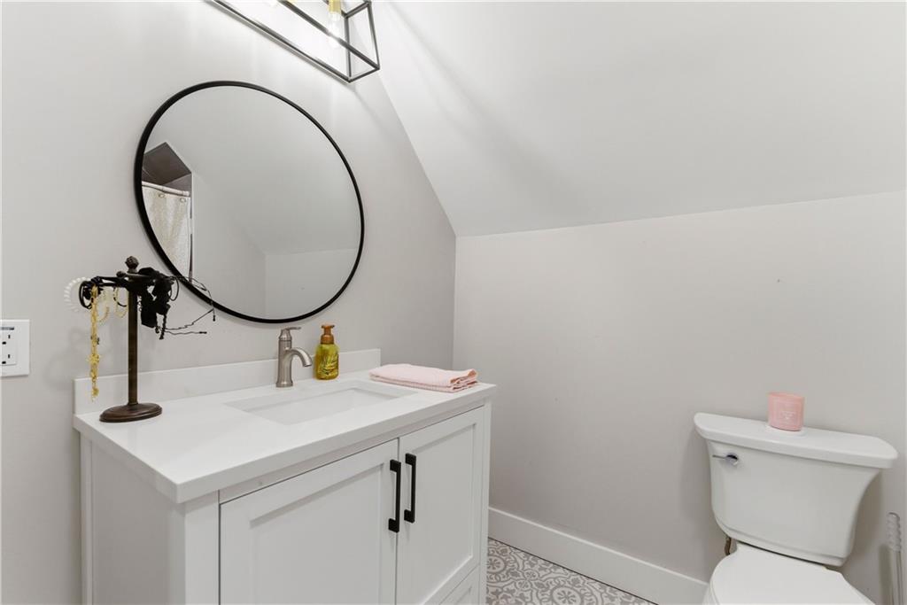 6754 Gaines Ferry Road Flowery Branch, GA 30542 - Photo 41 of 85 a bathroom with a sink and a mirror