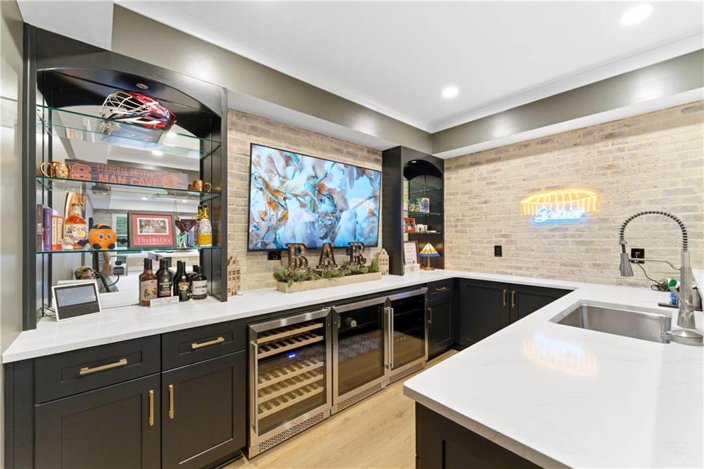 6754 Gaines Ferry Road Flowery Branch, GA 30542 - Photo 53 of 85 a kitchen with stainless steel appliances a sink and a large window