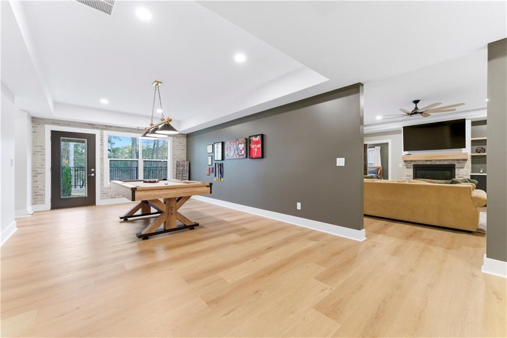 6754 Gaines Ferry Road Flowery Branch, GA 30542 - Photo 55 of 85 a living room with furniture and a flat screen tv