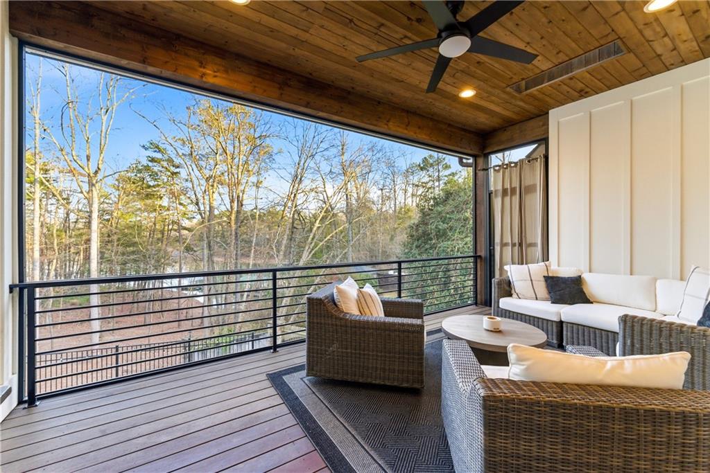 6754 Gaines Ferry Road Flowery Branch, GA 30542 - Photo 61 of 85 a balcony with furniture and wooden floor